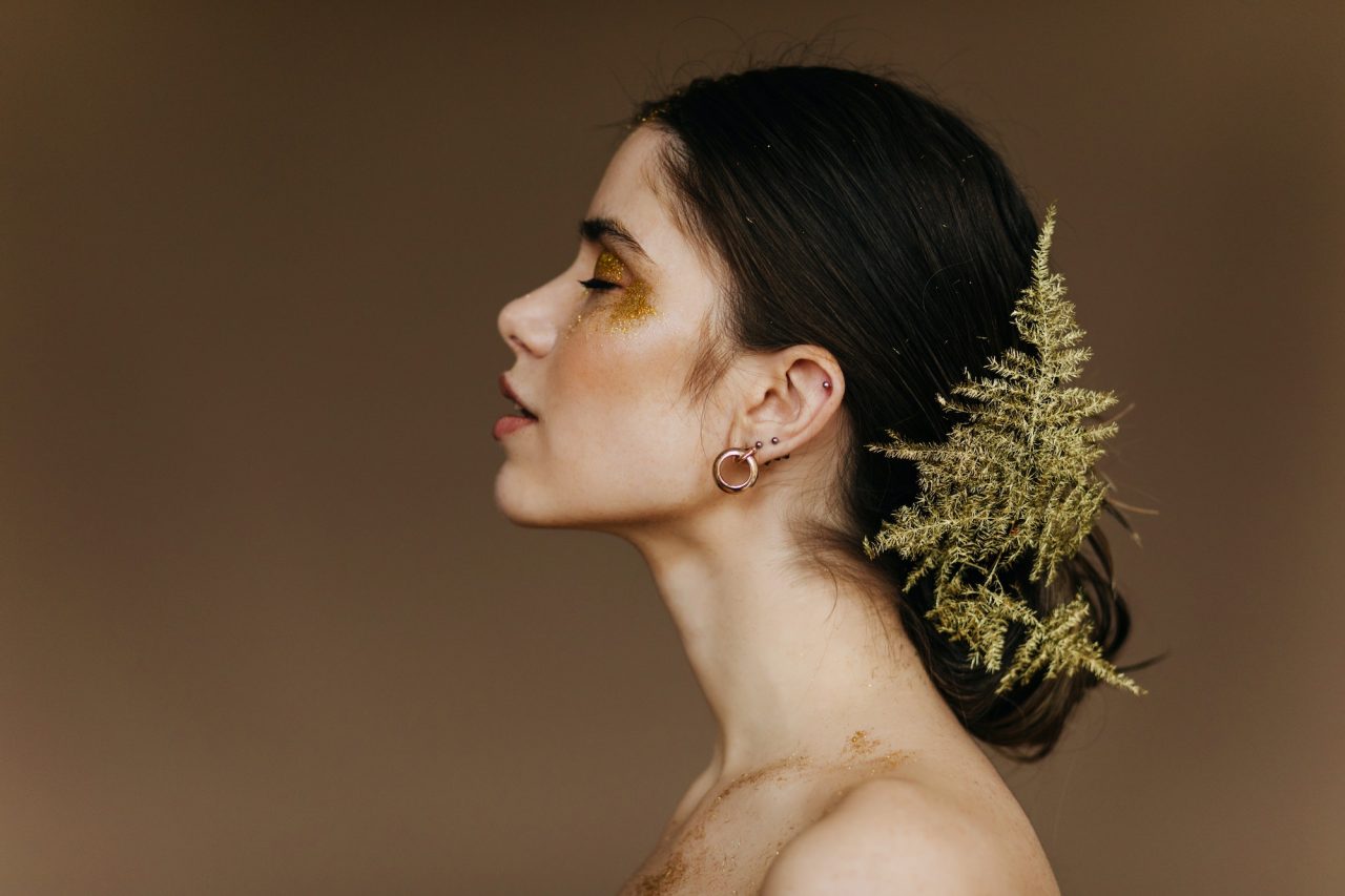 appealing-caucasian-girl-with-plant-in-hair-posing-in-studio-close-up-portrait-of-cute-european-wo.jpg